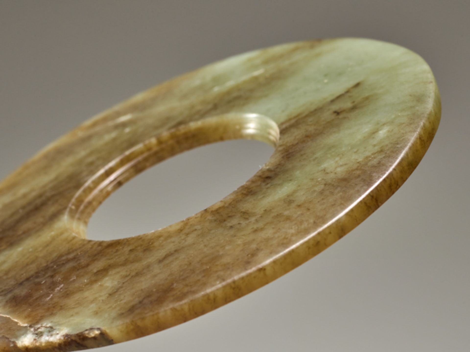 DISC IN SEMI-TRANSLUCENT JADEJade. China, Late Neolithic period, Qijia culture, c.2200-1900 - Image 4 of 5