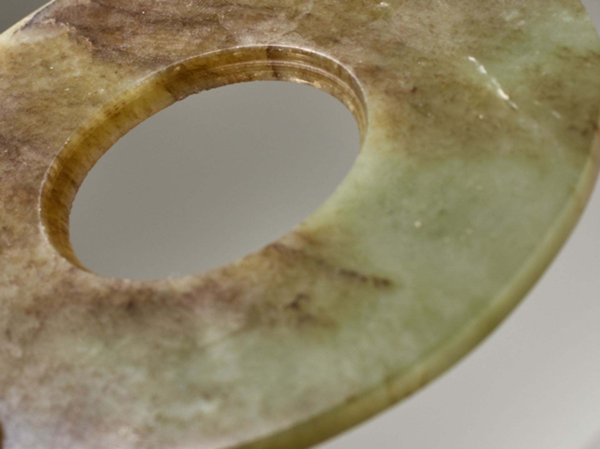 DISC IN SEMI-TRANSLUCENT JADEJade. China, Late Neolithic period, Qijia culture, c.2200-1900 - Image 3 of 5