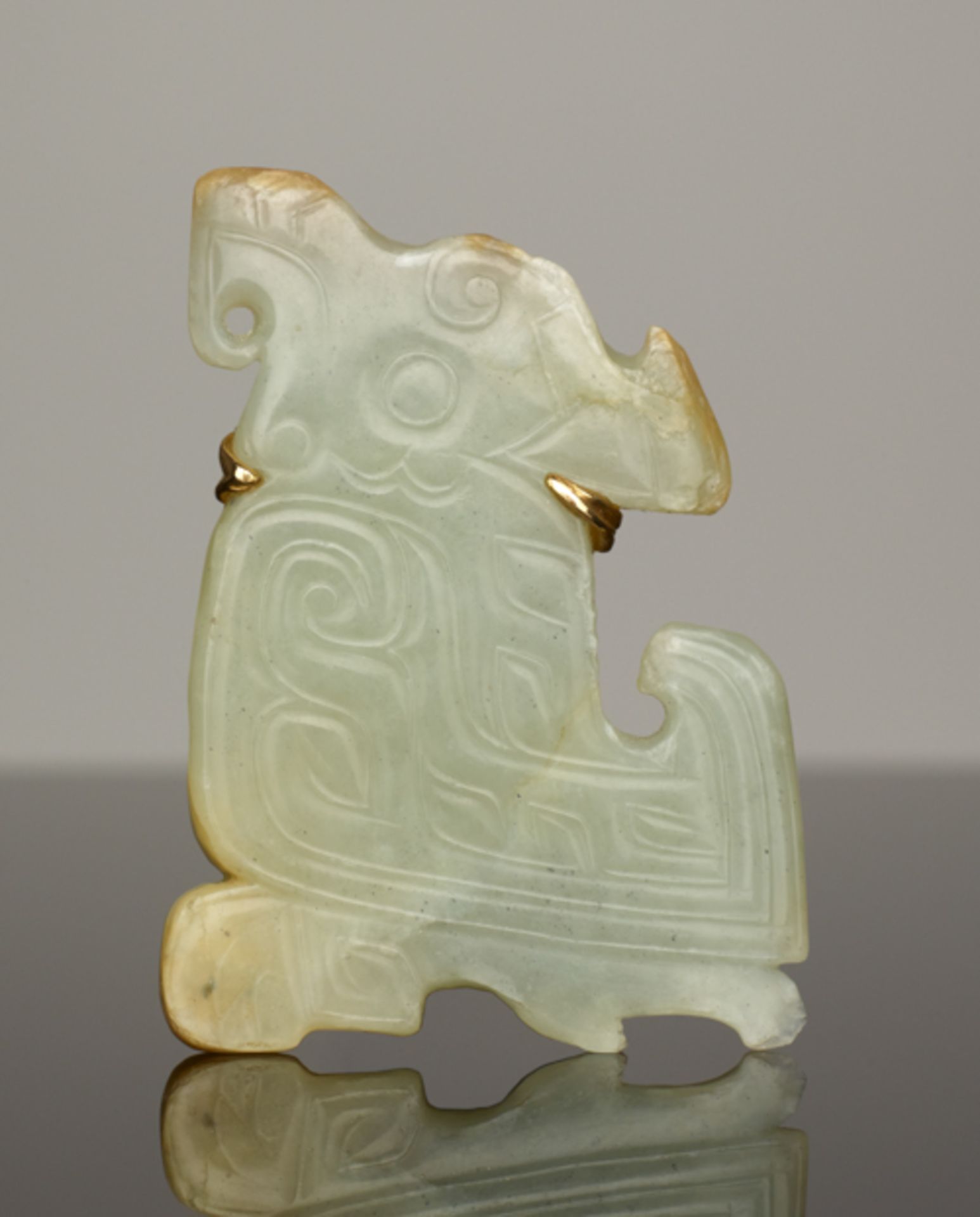 CARVING IN THE SHAPE OF A BIRDJade. China, Late Shang dynasty, ca. 1200 BCThis small, flat pendant