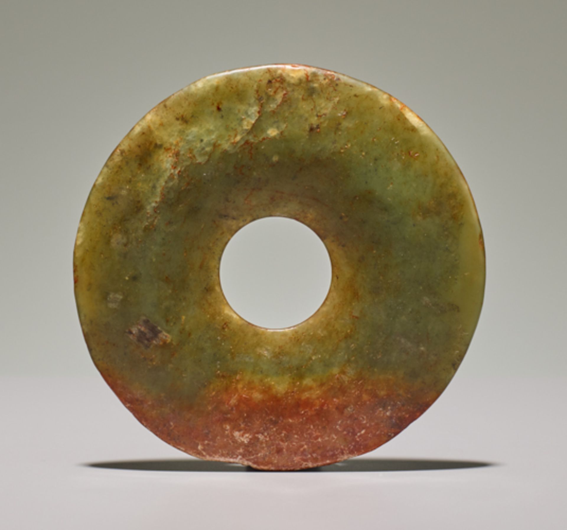 SMALL DISCJade. China, Late Neolithic period, early Bronze age, c.2500-2000 BCSmall disc in light