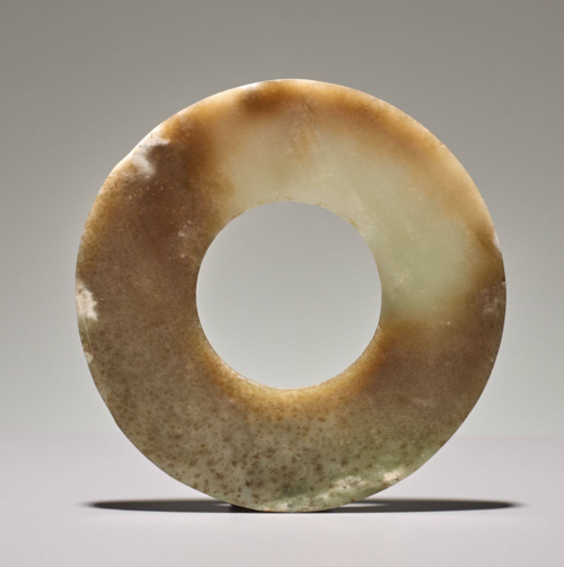 DISC IN SEMI-TRANSLUCENT JADE Jade. China, Late Neolithic period, Qijia culture, c.2200-1900 BC This - Image 2 of 4