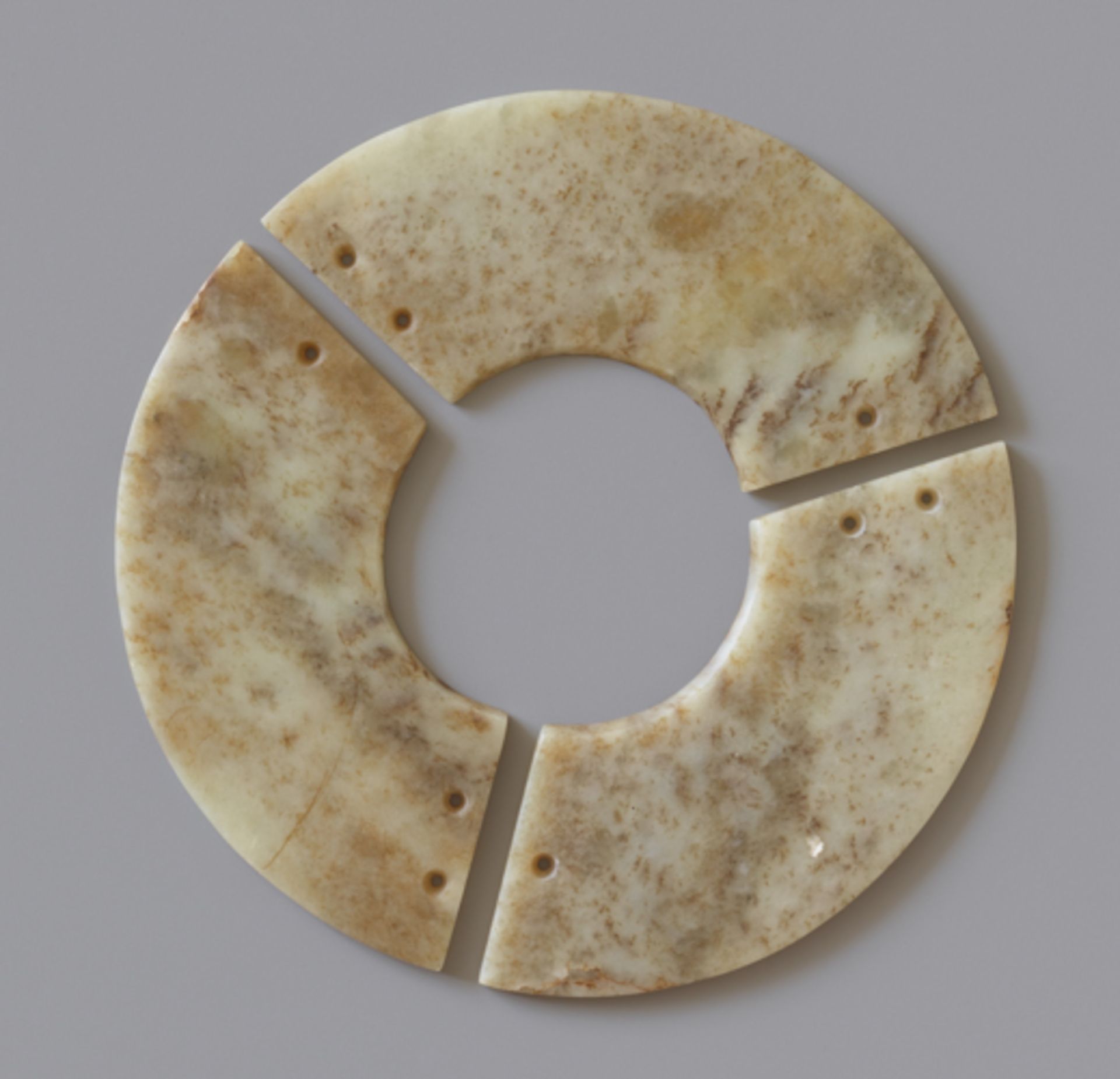 THREE-SECTION DISCJade. China, Late Neolithic period, Qijia culture, c.2200-1900 BCInstead of