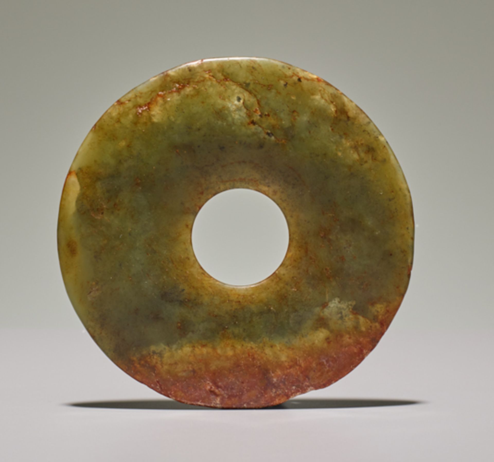 SMALL DISCJade. China, Late Neolithic period, early Bronze age, c.2500-2000 BCSmall disc in light - Image 2 of 4