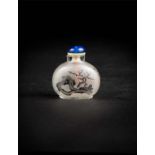 An inside painted snuff bottle with carp and seagrass motif on one side and tree and rocks on the