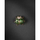 A gold and enamel ladybug brooch 18K gold with a green body and black dots, accented with eight