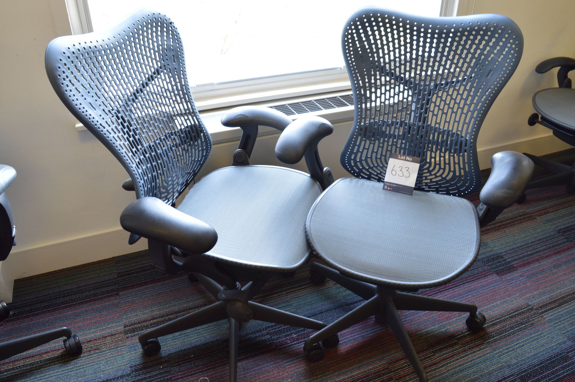 2 x Herman Miller, navy adjustable upholstered swivel elbow chairs