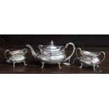 A George V silver three piece tea service to include tea pot, sugar bowl and cream jug,