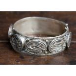 An Egyptian silver hinged bangle