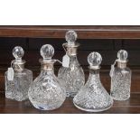 A set of five silver collared scent bottles,