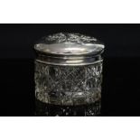 An Edwardian Art Nouveau style silver topped glass jar,