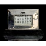 An Art Deco silver desk calendar, plain, rectangular form with glazed windows,