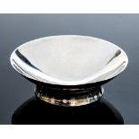 A modernist Britannia silver pedestal bowl, hand hammered dish form with waited cylinder foot, JMP,