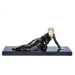 Menneville, an Art Deco lacquered and ivorine figure of a reclining woman, on marble base,