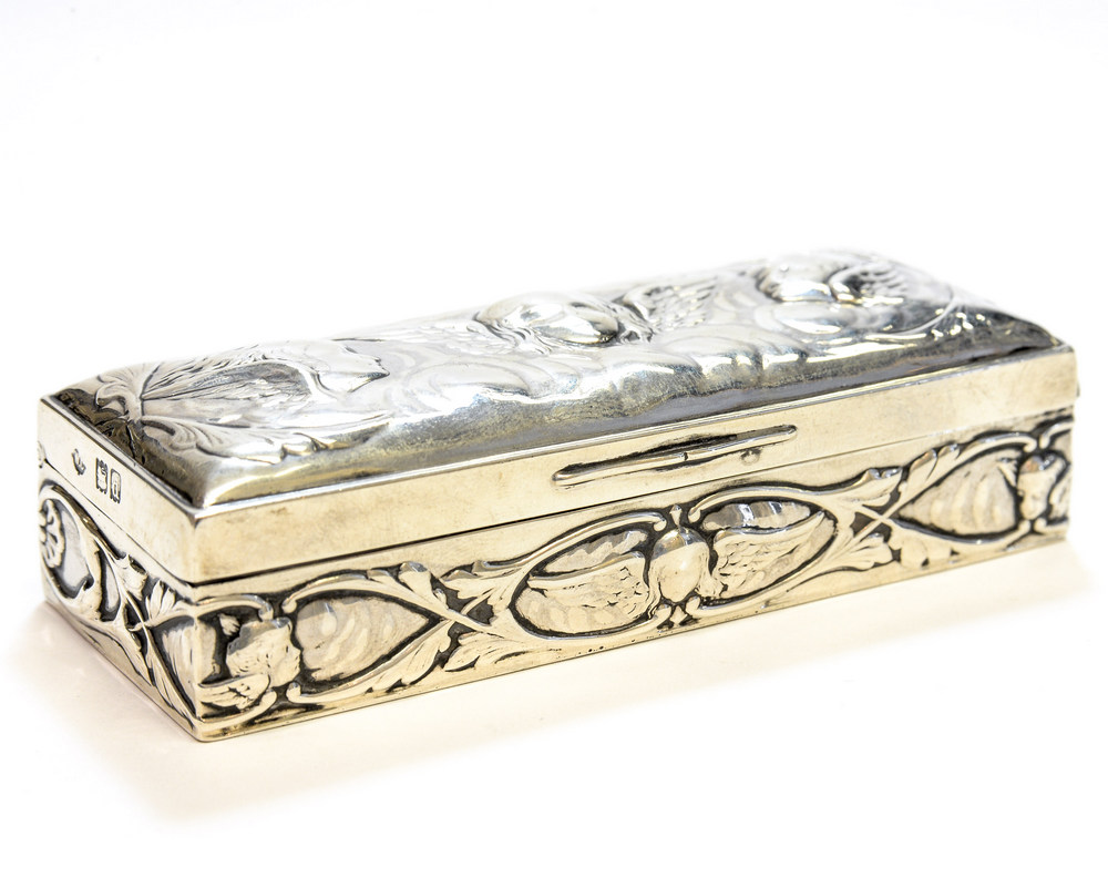 An Art Nouveau silver box, the lid embossed with Reynolds angels,