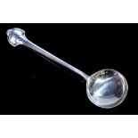 An Arts and Crafts silver preserve spoon, hammered finish with foliate Art Nouveau style terminal,