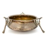 An Edwardian silver Art Nouveau dish on three organic tendril form supports,