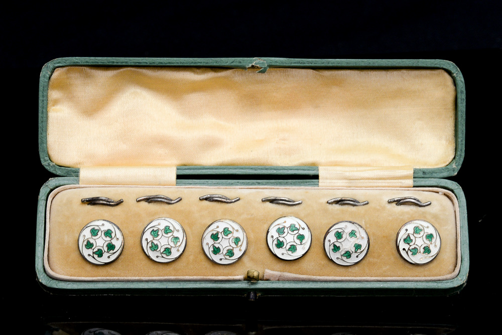 A set of six Arts and Crafts enamelled silver buttons,