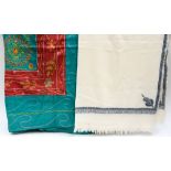 A cream hand woven shawl with hand embroidered decorative paisley design in blue/pinks/green,