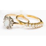 An 18 ct gold seven stone brilliant cut diamond ring, total diamond weight approx 0.2 ct, 2.