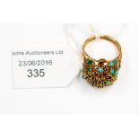 A Continental/Middle Eastern yellow metal cluster ring with turquoise, sapphire, emerald and ruby,