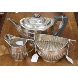 A late Victorian Goldsmiths and Silversmiths Company three piece silver tea service of oval form,