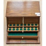 An oak two drawer lockable coin cabinet with key,