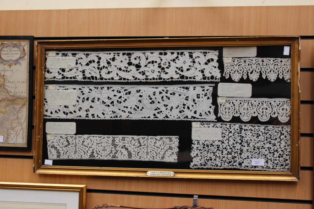 A large frame containing Italian 17th Century and 18th Century samples of bobbin lace,