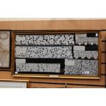 A large frame containing Italian 17th Century and 18th Century samples of bobbin lace,