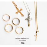 A 9 ct rose gold Crucifix pendant on five white chain, two other Crucifixes,