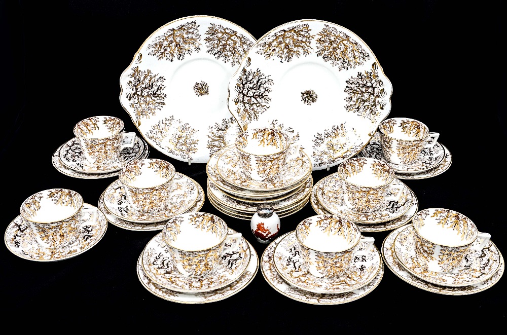 A part 19th Century ceramic tea service with gilt decoration, comprising cup, saucers,
