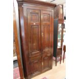 A George III oak corner cupboard,