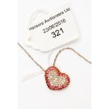 A diamond and ruby heart shape pendant, stamped 18 ct gold,