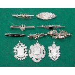A collection of silver pendants, all with vacant cartouches,