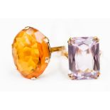 Two 9 ct gold stone set dress rings, one amethyst set the other orange stone set, gross weight 10.