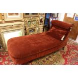 A mid Victorian chaise longue, upholstered in deep red,