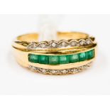 An emerald and diamond ring set in 18 ct yellow gold,