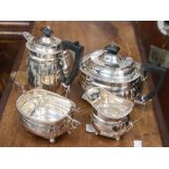 A Victorian four piece silver boat shape tea service with gold rim border, raised on four ball feet,