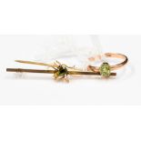 A peridot and yellow metal bar brooch,