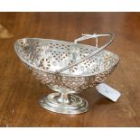 A George V silver pierced oval basket with swing handle, London 1907,