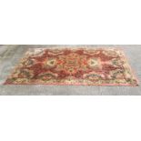 Persian style carpet, central floral motif, to a patterned floral background,