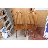 A pair of oak Windsor style chairs, with hooped backs, rod supports,