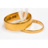 A 22 ct gold gentlemen's wedding band, ring size N1/2, together with a ladies' gold band,