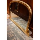 A reproduction gilt framed Victorian style over mantle mirror