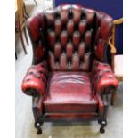 A traditional red leather deep buttoned three piece suite, comprising tub chair,