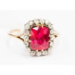 A yellow gold synthetic ruby and diamond ladies cluster ring,