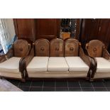 A George V beech framed three piece bergere suite, comprising three seater settee and two armchairs,