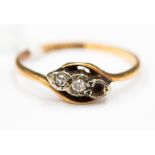 An 18 ct gold diamond three stone ring, one small diamond missing 2.0 grms approx ring size O.