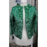 A vintage 1960s ladies' green-sequinned long sleeved evening jacket with seed pearl trim