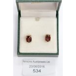 A pair of 9 ct gold and garnet earrings