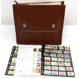 Two stamp albums and first day covers providing some mint GB face value in a leather briefcase